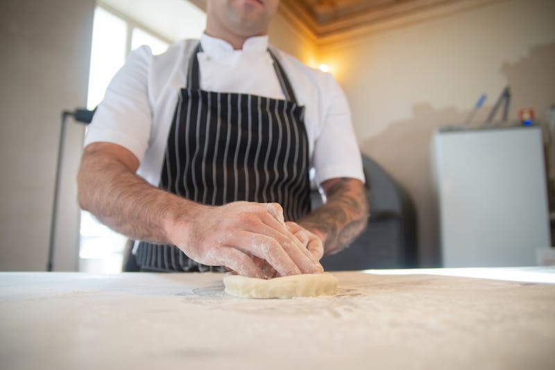 Jet's pizza being prepared fresh in our kitchen with quality ingredients