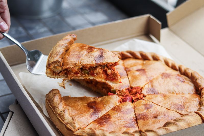 Four-cheese jets pizza with stretchy mozzarella pull
