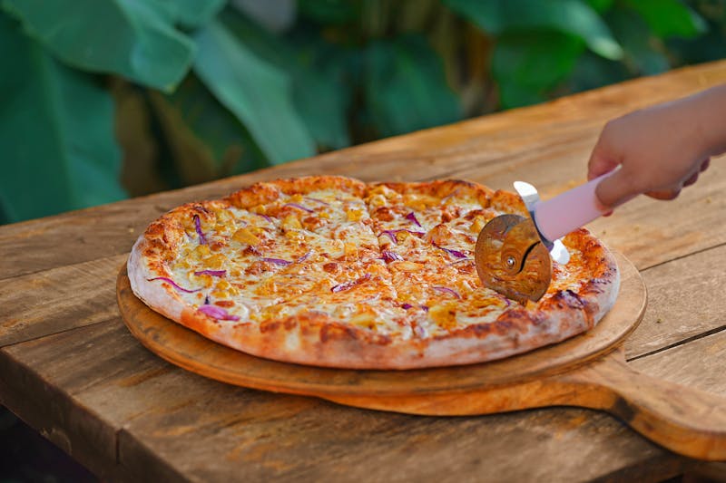 BBQ chicken jet's pizza with smoky sauce and fresh herbs